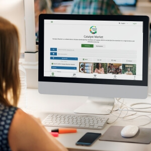 Woman using a laptop displaying the Catalyst Market