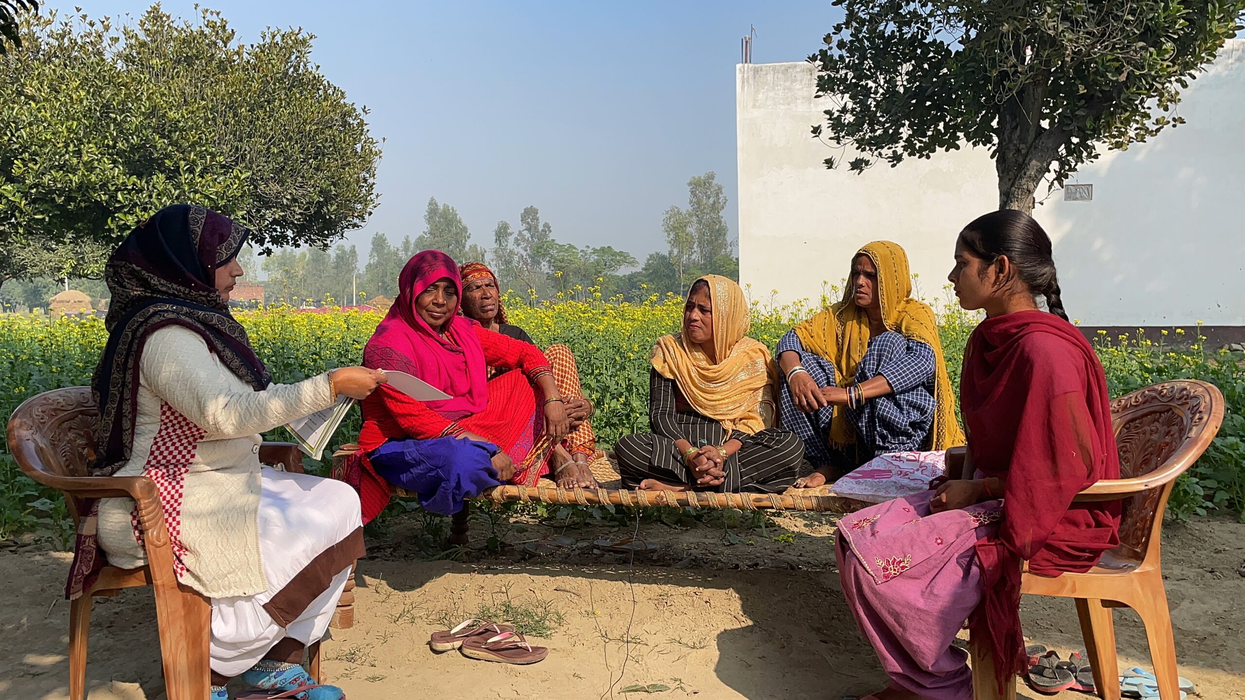 group of people sited outside in a circle