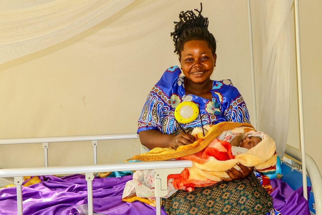 First new mother to receive a solar light upon launch of SB+HH program at the clinic